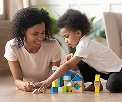 Woman and toddler playing with toys