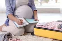 Pregant women packing with checklist