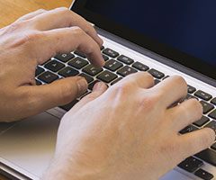 Person typing on keyboard