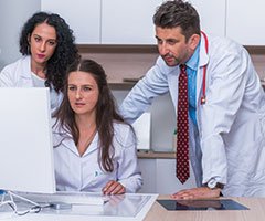 Team members looking at computer