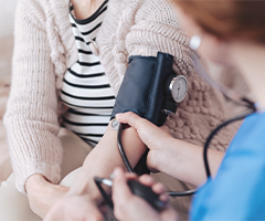 Nurse measuring patient blood pressure