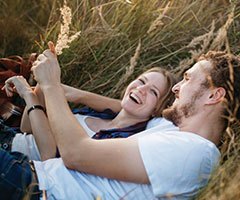 Man and woman laying in field