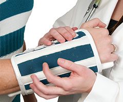 Physician bracing broken arm