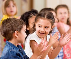 Group of children clapping