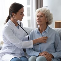 Physician listening to patients heart