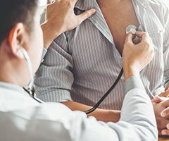 Physician using a stethoscope