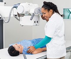 Technition preforming X-Ray on patient