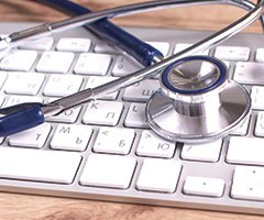 Stethoscope on keyboard, patient information