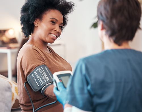 Nurse measuring patient blood pressure